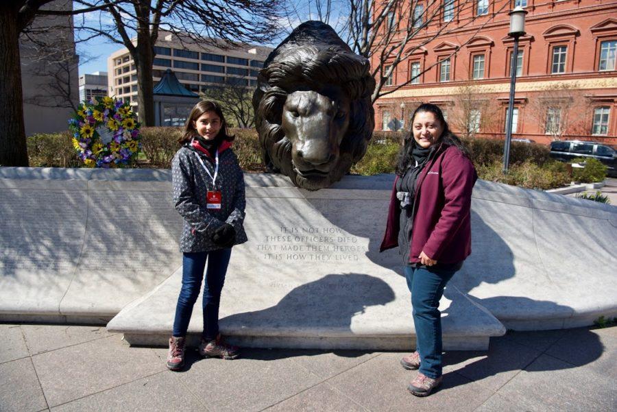 Savanna and her mom stand in front of the National Law Officers Enforcement Memorial in Washington DC where Savannas dad, Deputy Michael Arruda is commemorated.