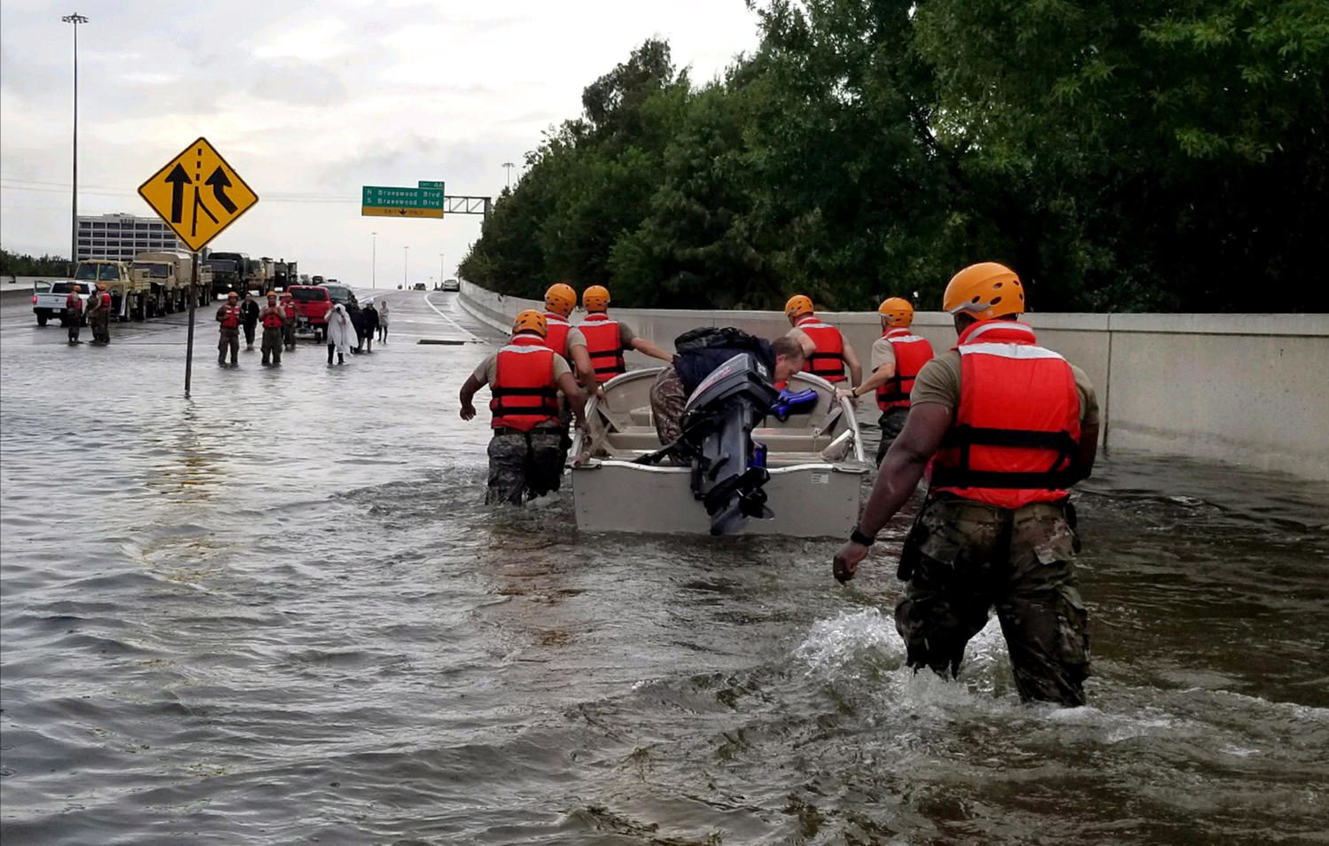 Soldiers with the Texas Army National Guard move through flooded Houston streets.