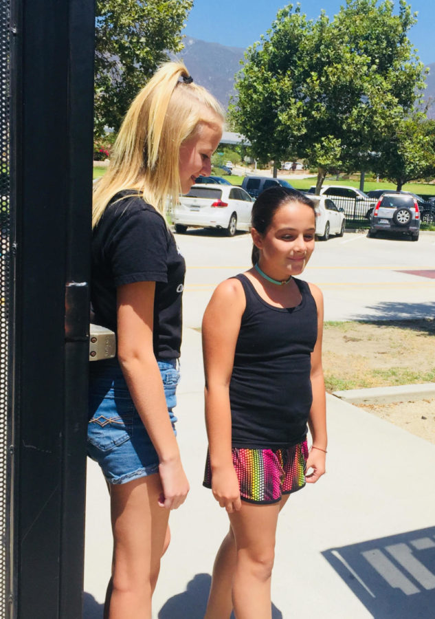An eighth grader welcomes in a new sixth grader. 