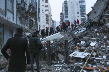 People help survivors of the massive earthquake out of the rubble
