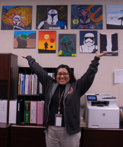 Mrs. Ramos shows off the artwork that she has in her office. 
