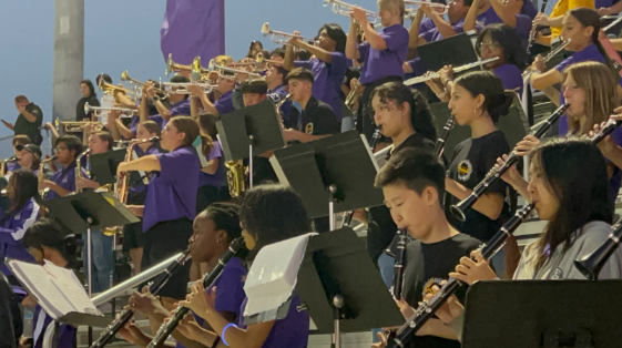 The Day Creek and Rancho High Band conducting their musical instruments during a football game. 