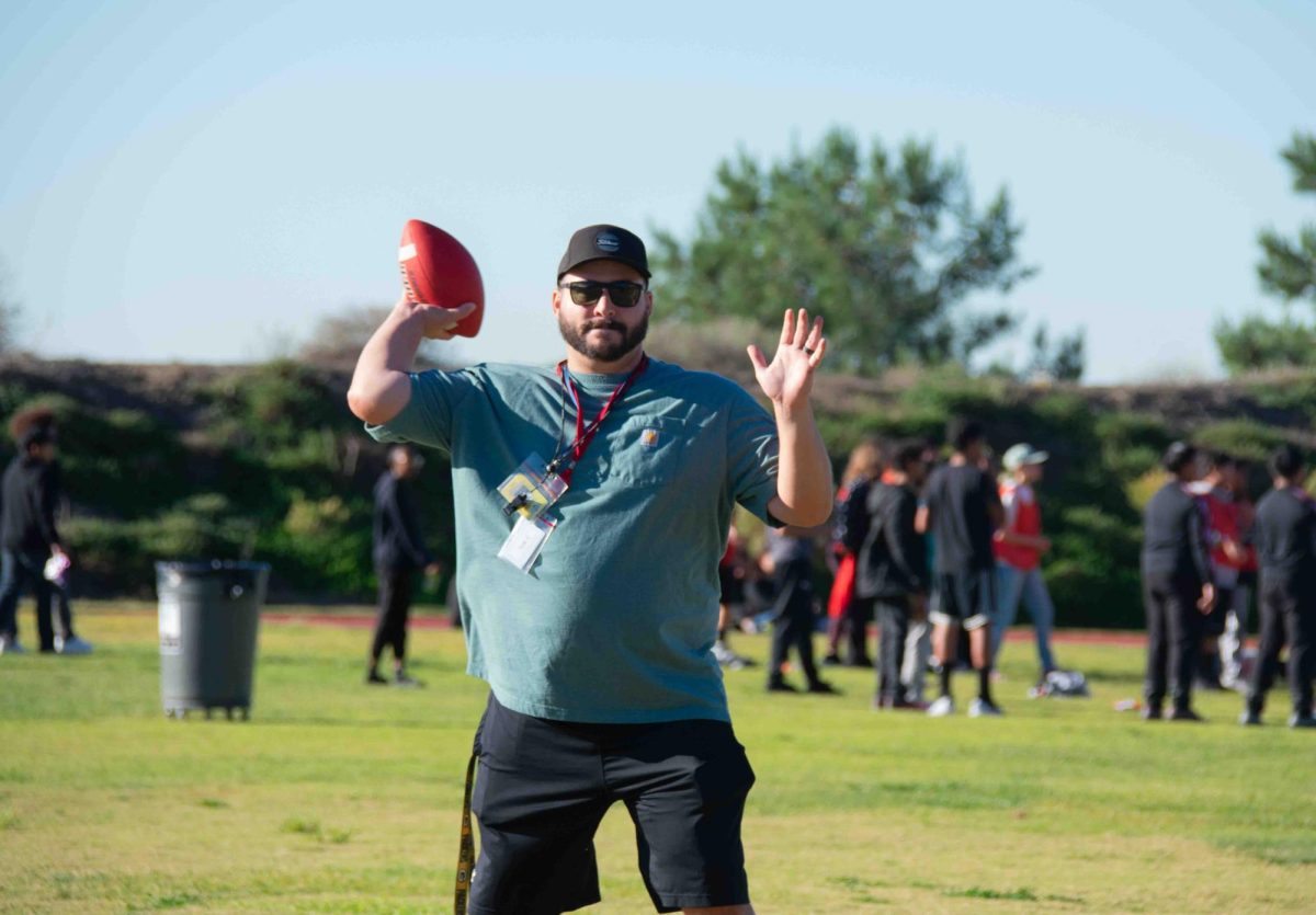 Mr. Marshall participating in Flag Football during the Kickball Tournament. 