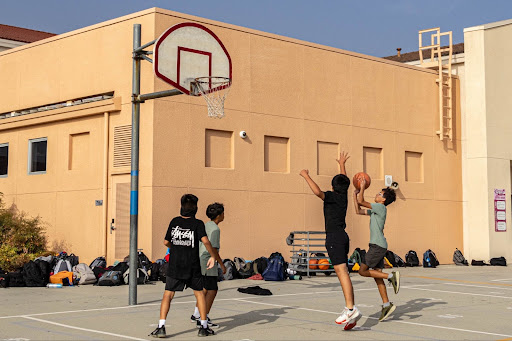 Four 7th grade Coyotes enjoying a 2-on-2 game.