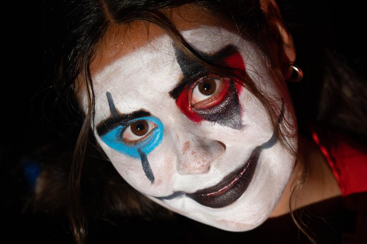 An 8th grader dressed up as a clown in the Halloween Maze.

