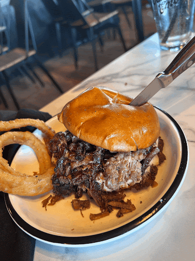 The Oak, a gourmet burger made with brisket, onion rings, beef wagyu, and American cheese.