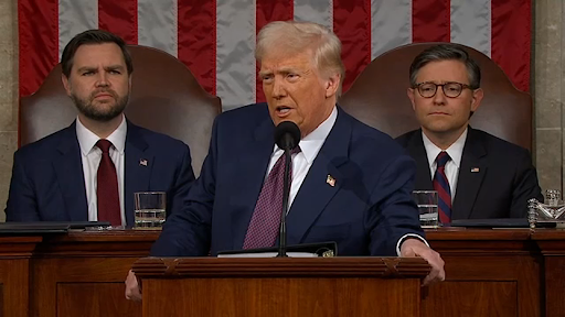 Trump (center) on the podium along with JD Vance (left) and Mike Johnson (right).

Photo Credits: 6ABC