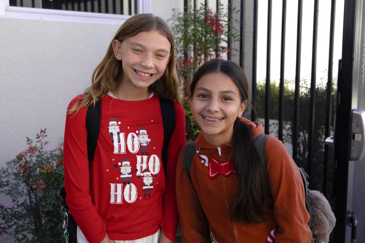 6th grade friends, Emma A. and Zia V., posing together with their spirt attire.