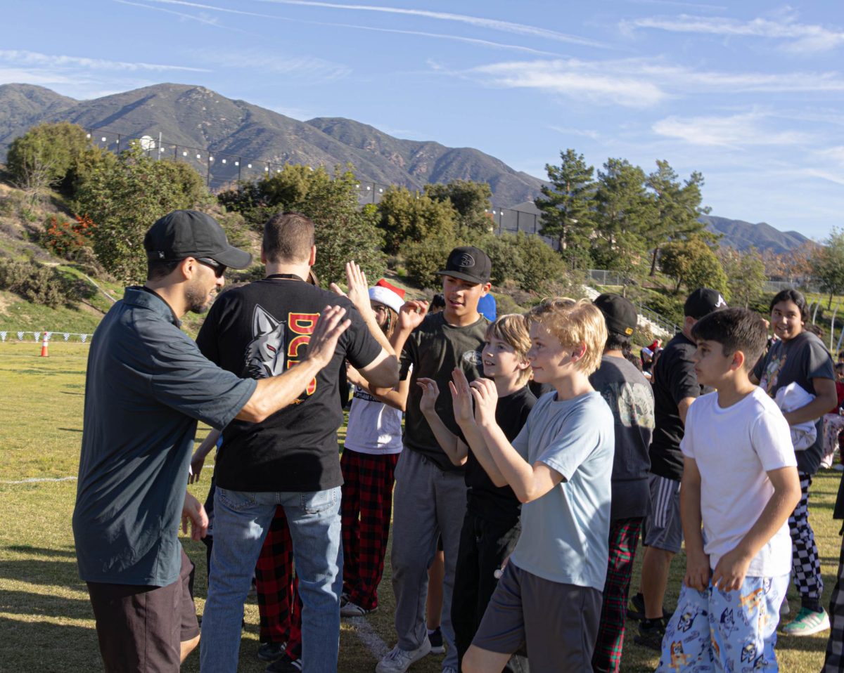 Members of the student team congratulate the teacher team after they win.