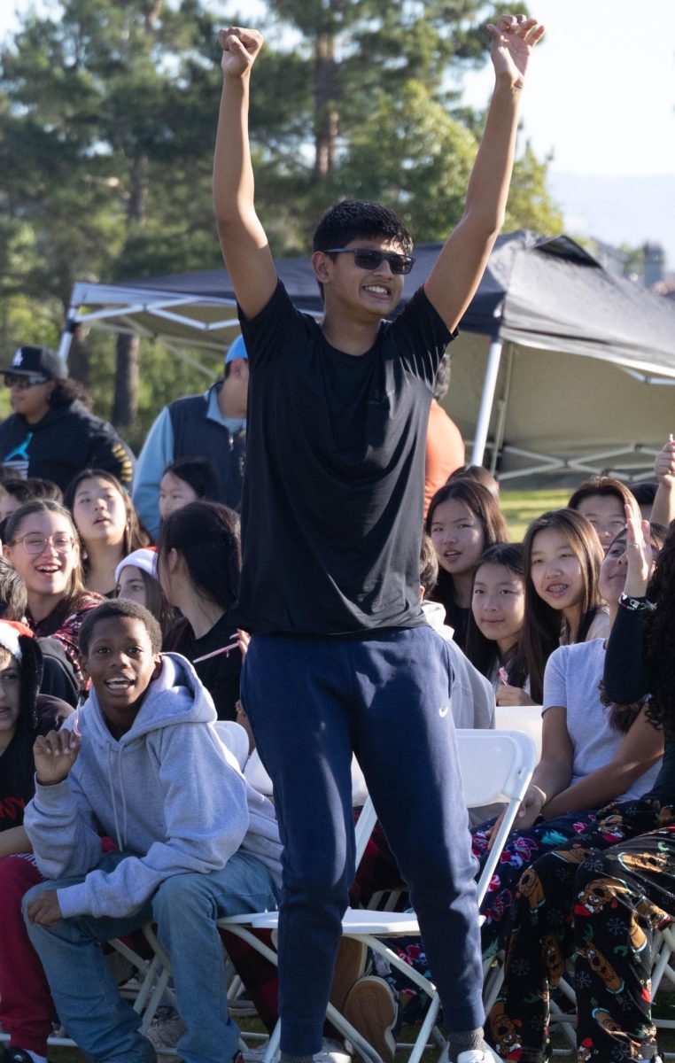 Riaan D. leads cheers from the student section.