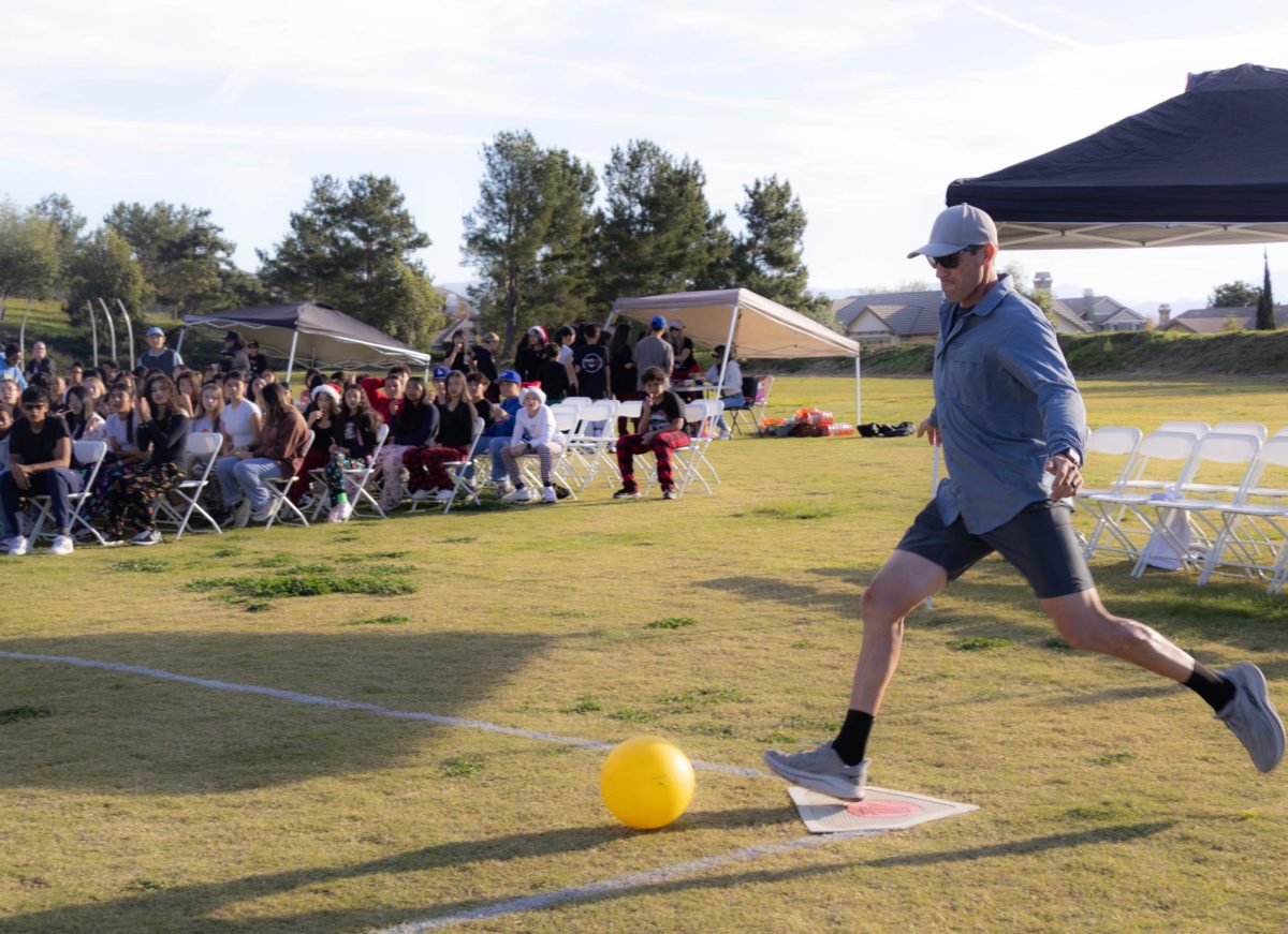 Mr. Hernandez kicks the ball into play.